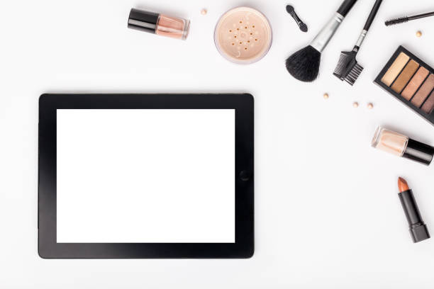 istock set of professional decorative cosmetics and makeup tools with tablet on white background with copy space for text. beauty, fashion, party and shopping concept. flat lay frame composition, top view 944152442