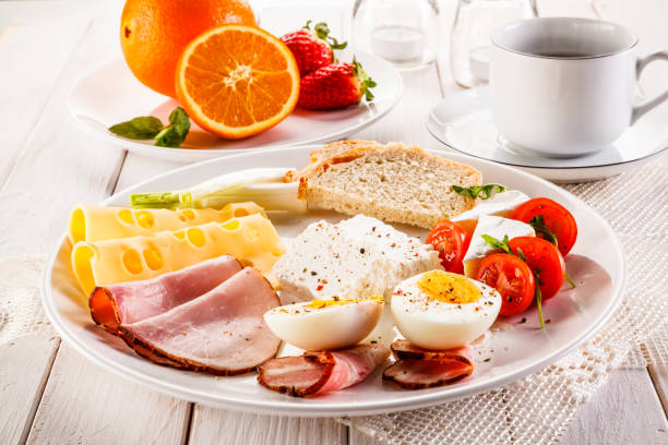 istock Breakfast - boiled egg, smoked salmon, cheese, ham and vegetables 944154064