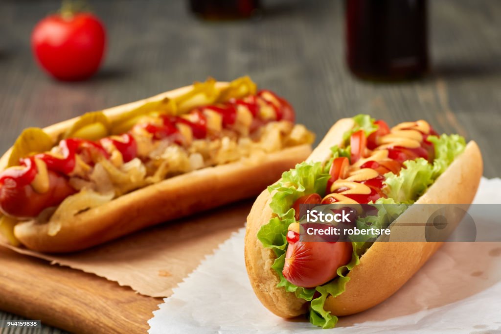 Two juicy hot dogd with vegetables Two juicy hot dogs with vegetables. Selective focus Hot Dog Stock Photo