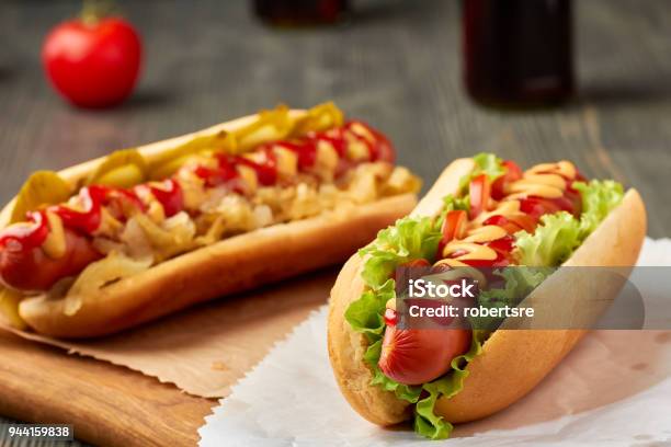 Two Juicy Hot Dogd With Vegetables Stock Photo - Download Image Now - Hot Dog, Macrophotography, Pork