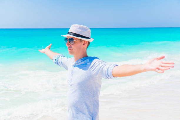 istock Young man on the beach resting alone outdoor 944160306