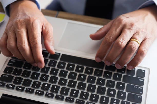 istock Cropped Hands Of Businessman Using Laptop At Office 944162816