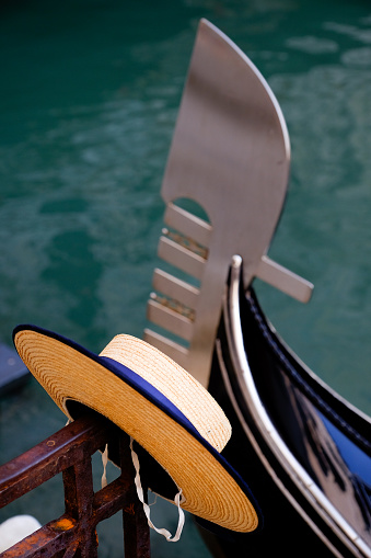 Gondoliers straw boater hat and the bow of a Gondola in Venice Italy