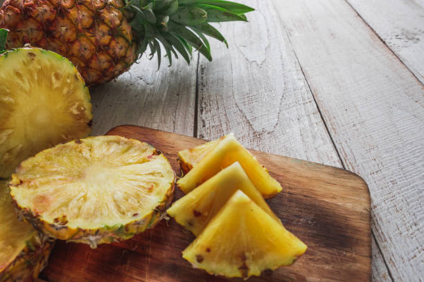 istock pineapple on the wood texture background 944179978