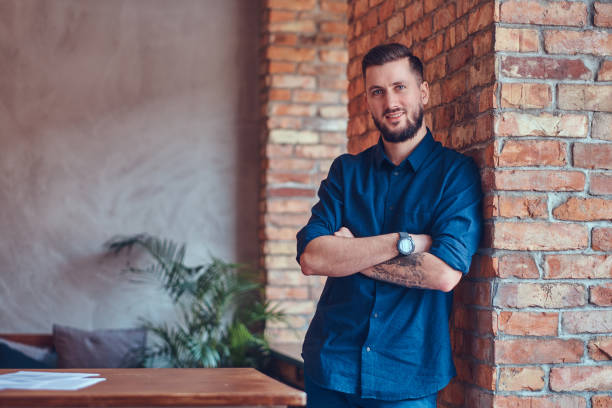 istock Studio portrait of a bearded handsome hipster wearing a blue shi 944193218