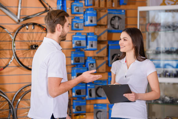 istock smiling young managers looking at each other while working together in bicycle shop 944200126