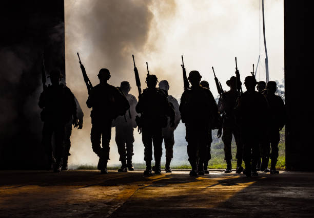 istock Army Soldier With Rifle Walking Against Sky 944200212