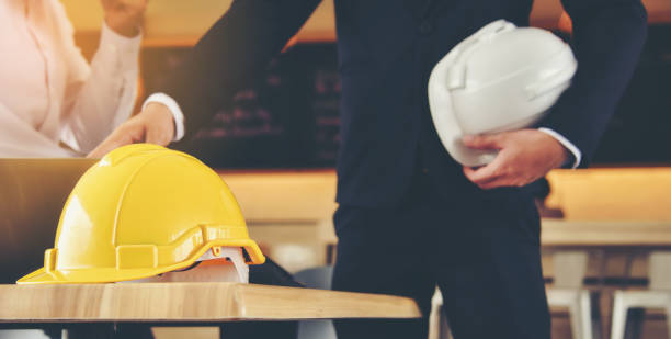 istock Midsection Of Architect With Hardhats 944210742