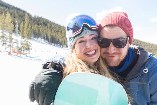 istock Happy young couple snowboard together 944217504