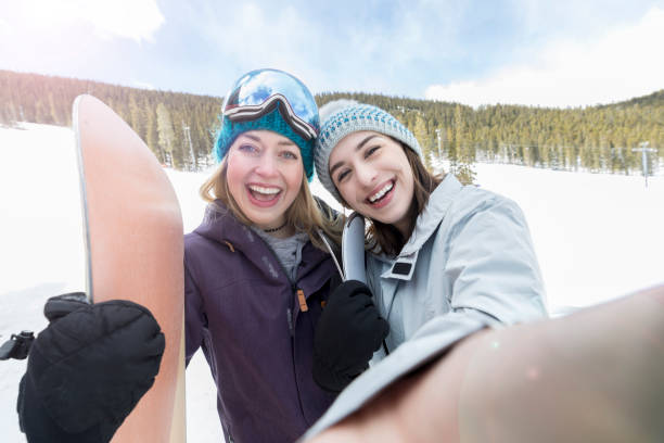 istock Happy friends take selfie on ski slopes 944217546