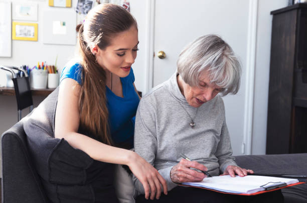 istock Daughter assisting her mother filling documents 944217658