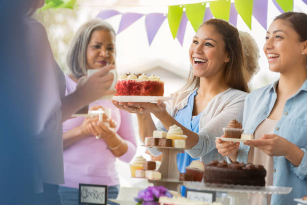 istock Hostesses serving dessert during cancer awareness event 944221306