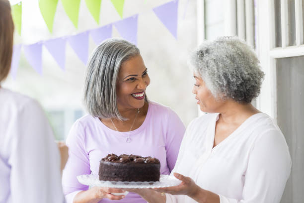 istock Women buy cake during cancer fundraiser 944221338