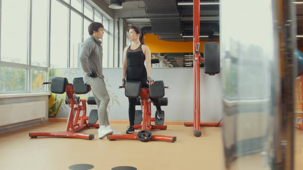 istock Young woman talking with coacher in workout room 944222318