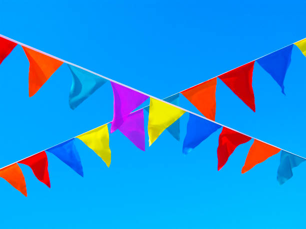 istock Multicolored flags, crossing ribbons in the sky 944228056