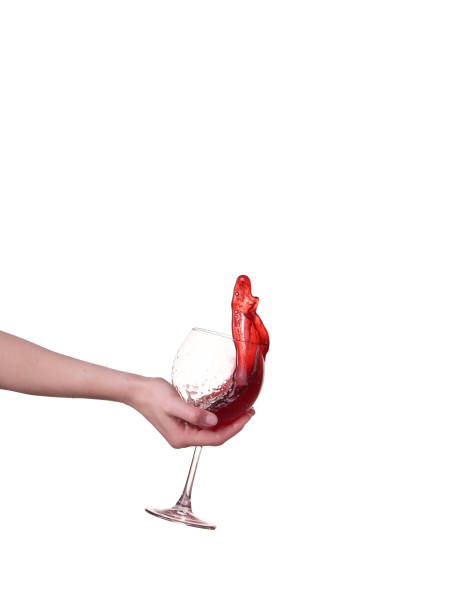 Red wine splashing from glass, isolated on white background