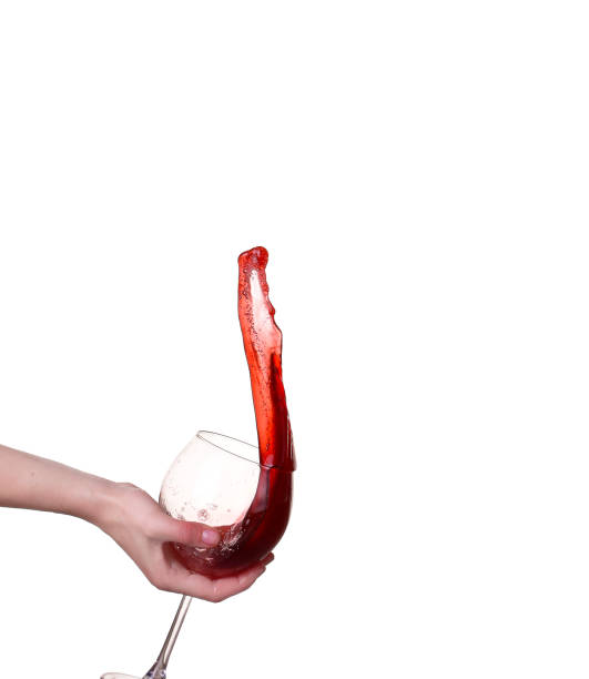 Red wine splashing from glass, isolated on white background