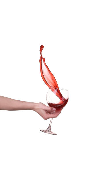 Red wine splashing from glass, isolated on white background