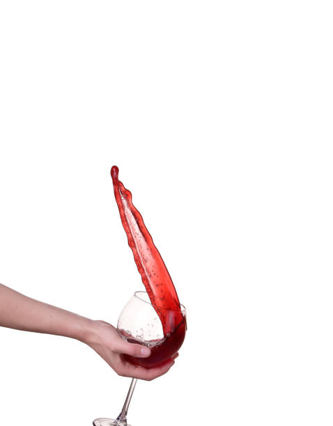 Red wine splashing from glass, isolated on white background