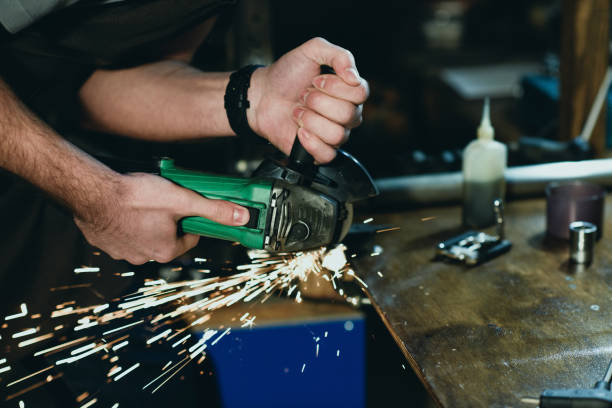 istock close-up partial view of man cutting metal with angle grinder in workshop 944230630