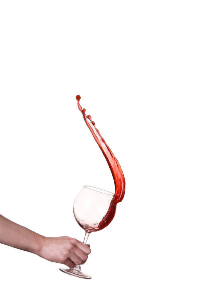 Red wine splashing from glass, isolated on white background