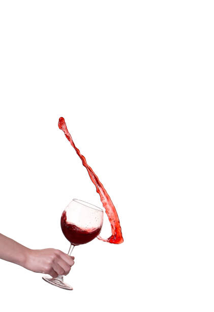 Red wine splashing from glass, isolated on white background