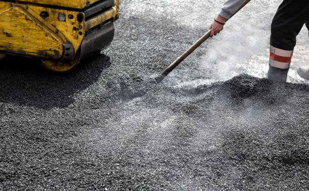 Worker with roller compacting asphalt on a road A roller compacting asphalt on a road compactor photos stock pictures, royalty-free photos & images