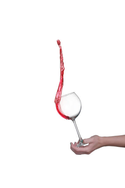 Red wine splashing from glass, isolated on white background