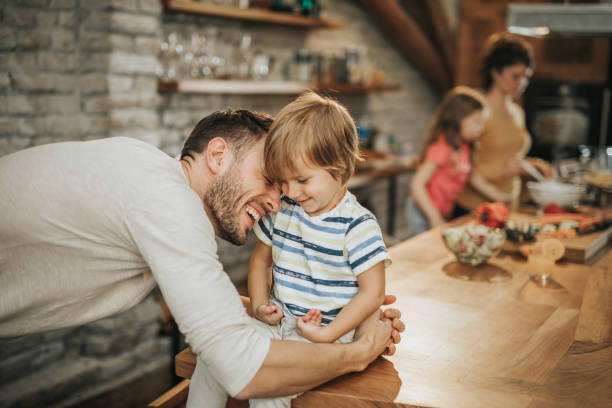 istock Happy father and son showing affection in the kitchen. 944255094