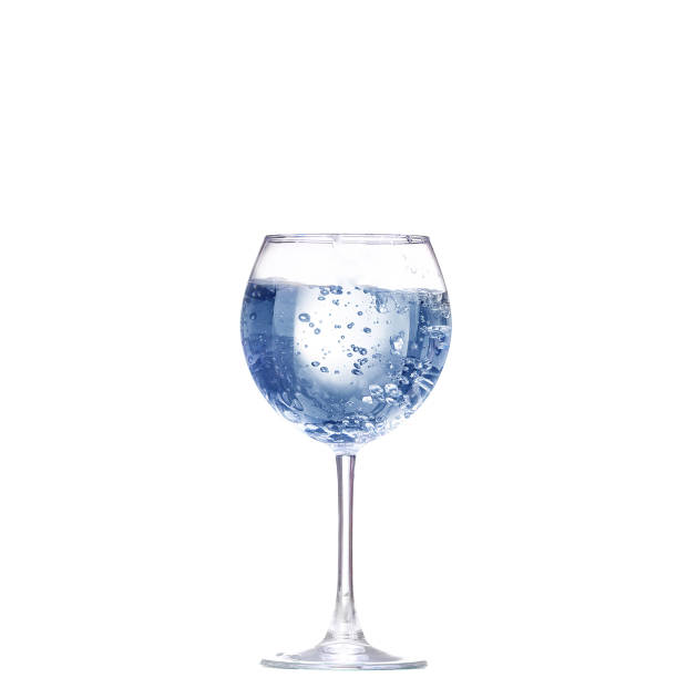 istock Pouring water from glass pitcher on white background 944258348