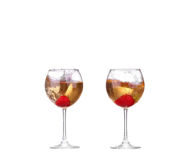 istock collage Single Strawberry splashing into a glass of wine 944258404