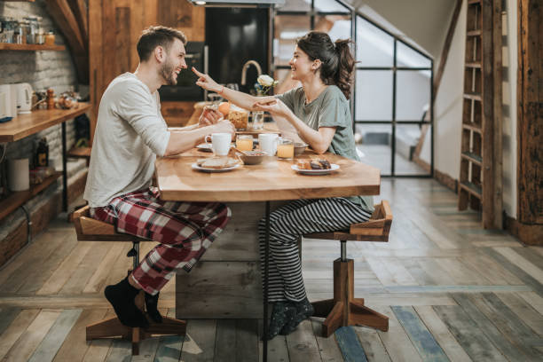 istock Playful couple having fun during breakfast in the morning. 944266094
