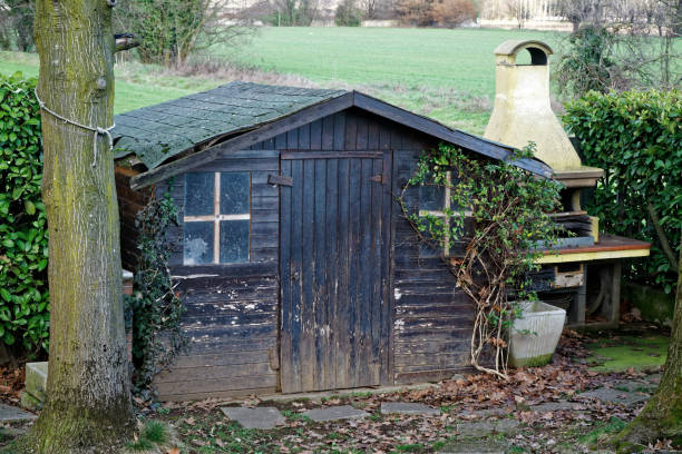 istock Old desolate barn with dirty vintage window, cute small house on back yard 944266232