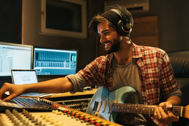istock Attractive guitarist playing a guitar in music studio 944270190