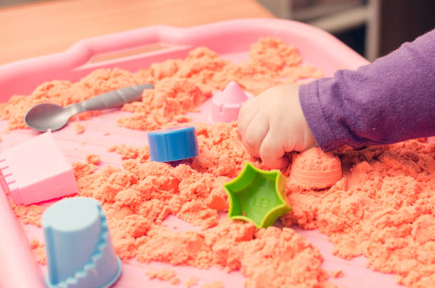 istock The hands of a child playing with kinetic sand 944270944