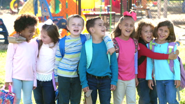 Multi-ethnic school children standing in a row