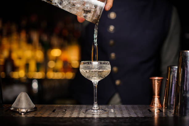 istock Bartender pouring a ready alcoholic cocktail into the glass 944272254