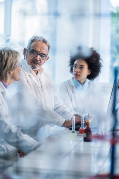 istock Team of biotechnologists communicating while working on desktop PC in laboratory. 944278324