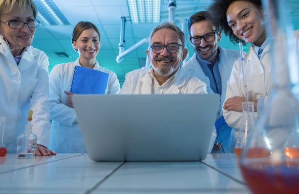 istock Team of happy scientists using laptop for new research in laboratory. 944278882