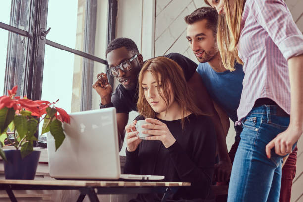 istock Group of multiracial students working with a laptop. 944285580