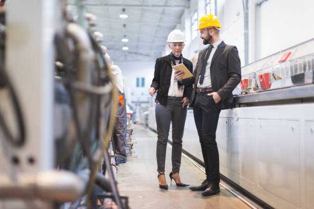 istock Quality inspectors in high tech factory 944293986