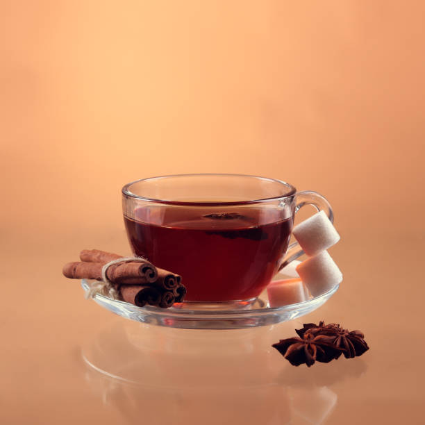 istock Cup of tea on glass with orange background 944297478