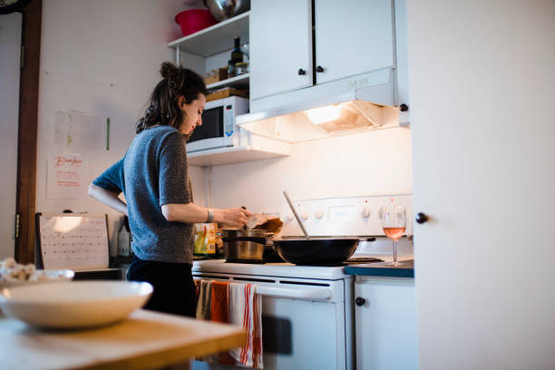 istock Young woman cooking in the kitchen 944299578