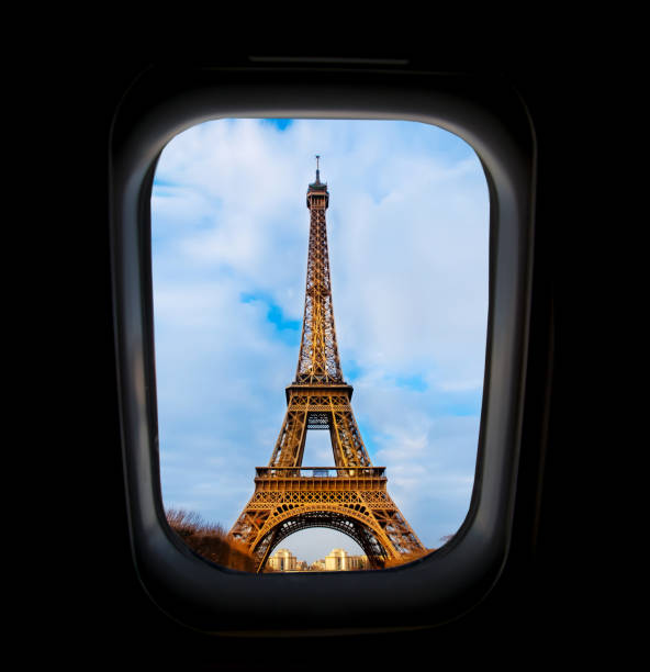 istock Skyscape through aeroplane window during flight in wing with blue sky. View of Eiffel tower in Paris 944300224