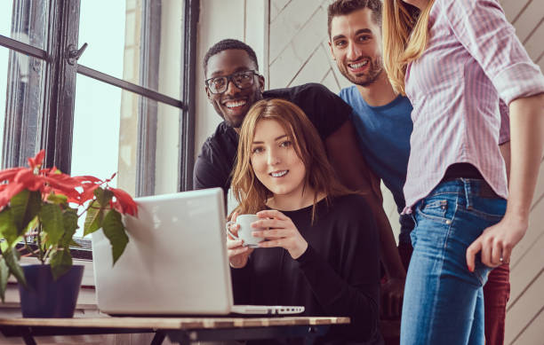 istock Group of multiracial students working with a laptop. 944304186
