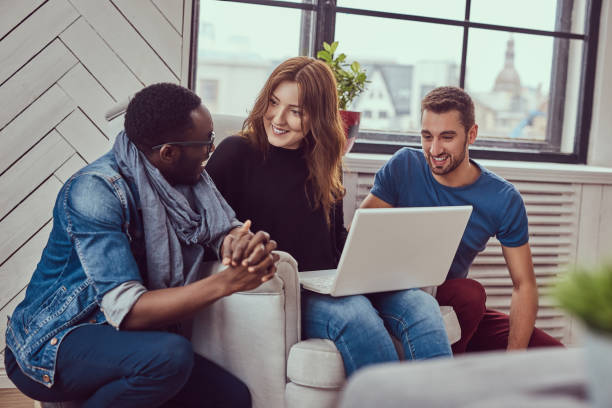 istock Group of multiracial students working with a laptop. 944304658