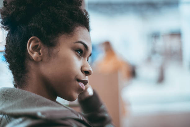 istock Young black female is looking aside, portrait 944310720