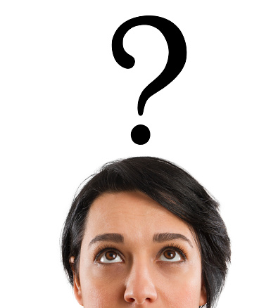 Young woman is looking up with question marks
