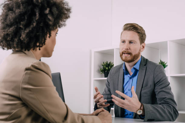 istock Man discussing business with a woman 944314242