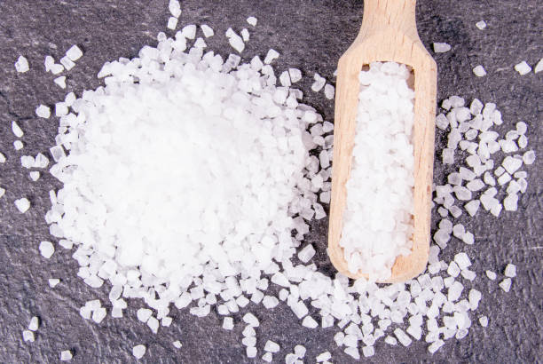 istock Coarse sea salt on dark background. Top view. 944317548
